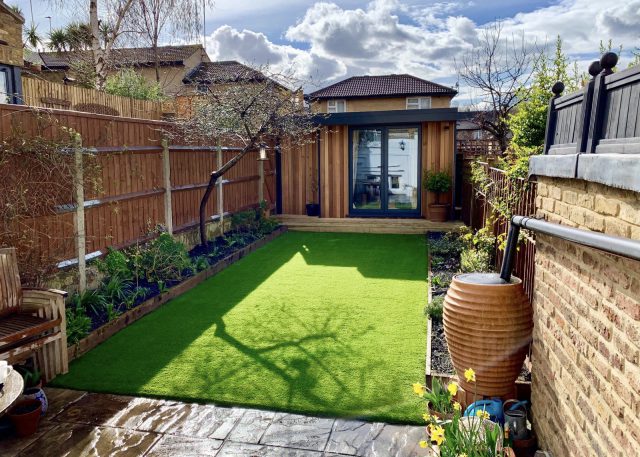Large flat garden with artificial grass.